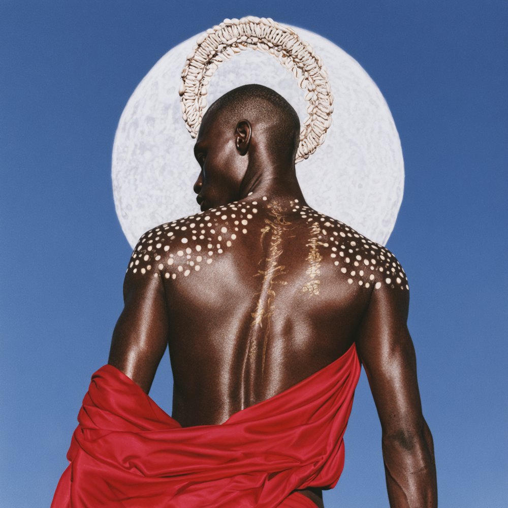 Only I'll Know — single cover art by Rebecca Muze for VELA: a figure beneath a full moon wearing a cowrie-shell halo crown, draped in red silk against cobalt blue